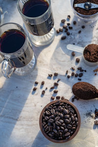 Still life with glass mugs of black coffee drinks making coffee at home