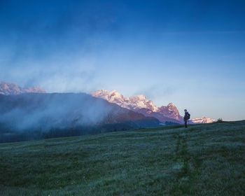 Man standing on field against sky