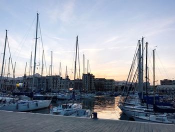 Boats in harbor at sunset