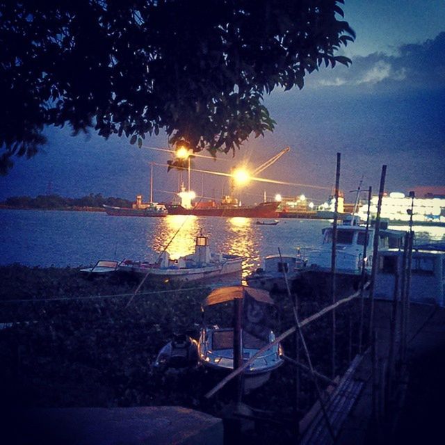 VIEW OF BOATS IN CALM SEA AT NIGHT