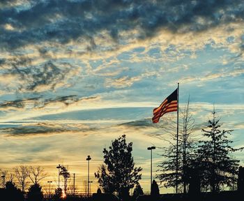 Low angle view of flag against sky during sunset