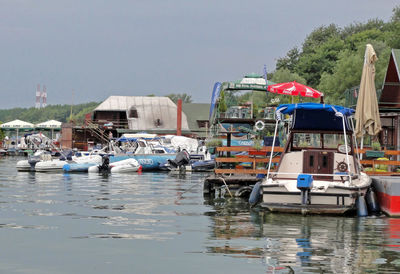 Boats moored on sea against clear sky