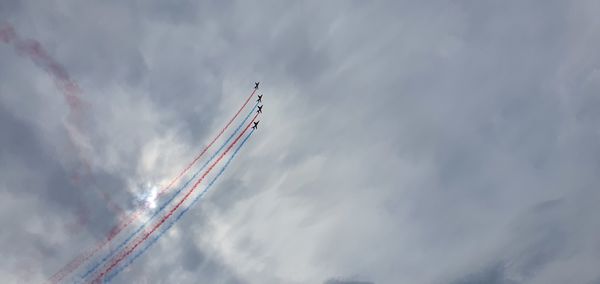 Low angle view of airplane flying against sky