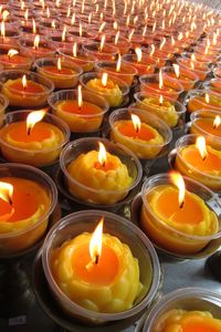 High angle view of lit tea candles