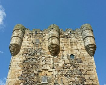 Low angle view of fort against blue sky