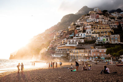 People on beach against sky