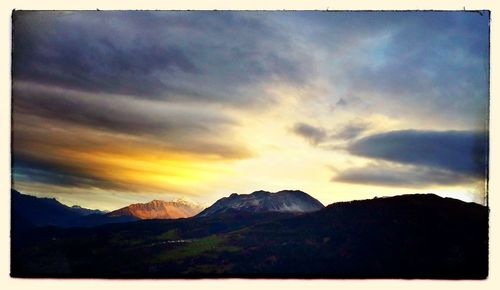 Scenic view of mountains against cloudy sky