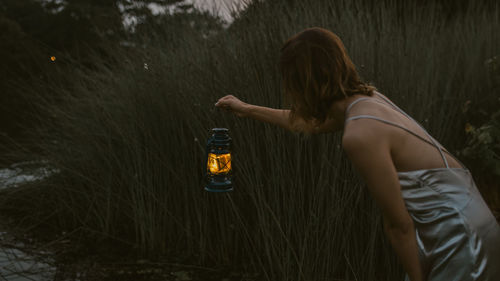 Rear view of woman standing in water