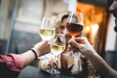 Midsection of woman holding drink in restaurant