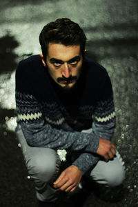 Portrait of young man sitting outdoors