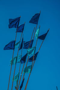 Low angle view of windmill against clear blue sky
