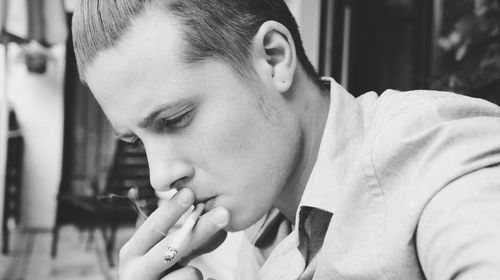 Close-up of young man smoking outdoors