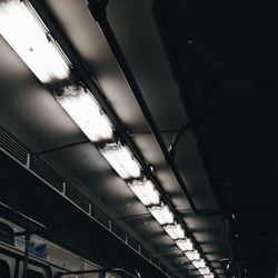 Low angle view of illuminated electric lights against sky