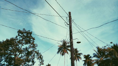 Low angle view of electricity pylon against sky