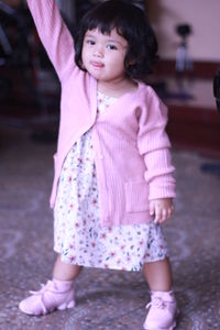 Full length of cute girl looking away