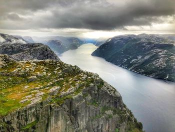 Scenic view of fjord amidst mountain