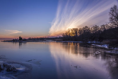 Scenic view of lake at sunset