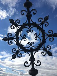 Low angle view of street light against cloudy sky