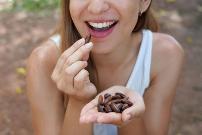 Cropped image of woman holding food