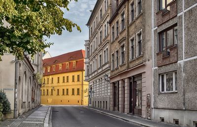 Street amidst buildings against sky