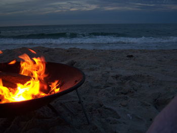 Fire pit on shore at dusk