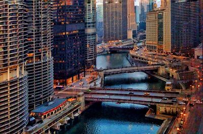 High angle view of bridge over river amidst buildings in city