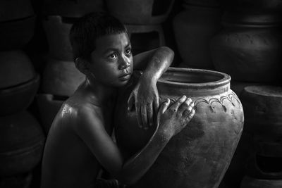 Full length of shirtless boy looking at camera