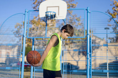 Boy playing basketball on court