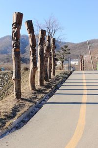 Road amidst trees against sky