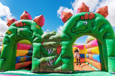 Multi colored sculpture in amusement park against sky