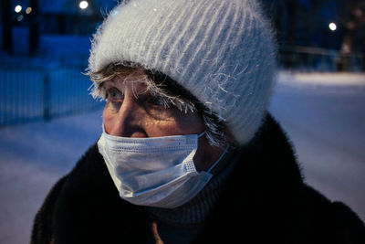 Close-up if senior man wearing mask standing outdoors