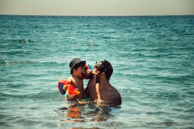 Happy father with son in sea
