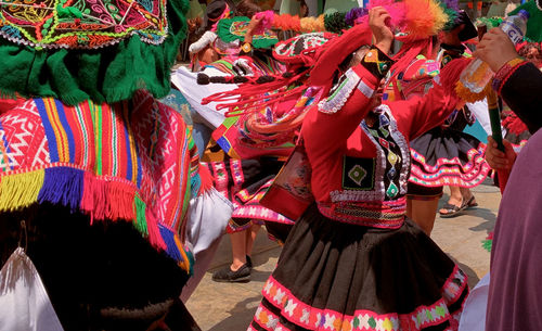 Group of people in traditional clothing  dancing during festival