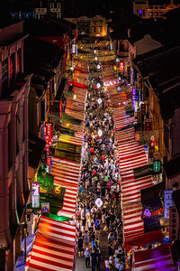 High angle view of illuminated buildings in city at night