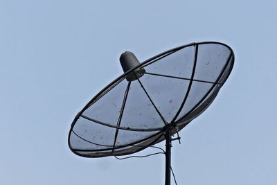 Low angle view of satellite dish against clear blue sky