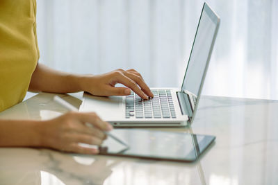 Low angle view of person using laptop on table