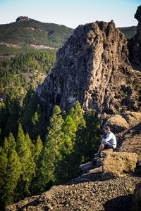 Man on rock against mountains