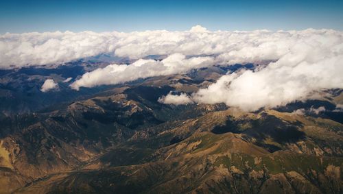 Scenic view of mountains against cloudy sky