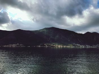 Scenic view of sea and mountains against sky