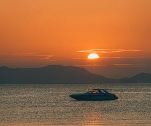 Scenic view of sea against orange sky