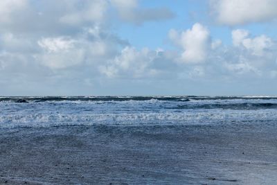 Scenic view of sea against cloudy sky