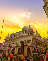 Group of people in front of temple at sunset