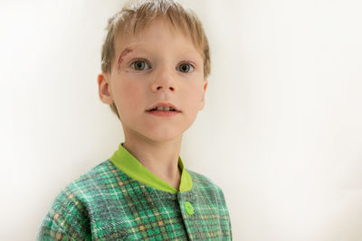 Portrait of cute boy against white background