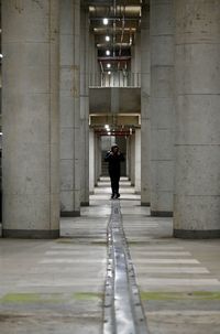 Rear view of man walking in building