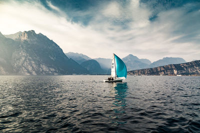 Sailboat sailing in sea against sky