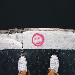 Low section of person standing on tiled floor