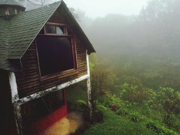 House by trees against sky