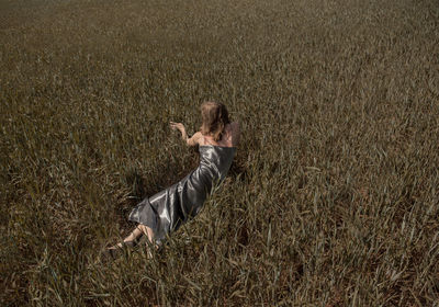 High angle view of woman lying on field