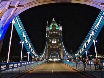 Illuminated bridge at night