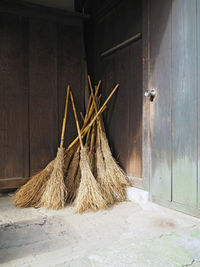 Wooden brooms leaning on wall at temple